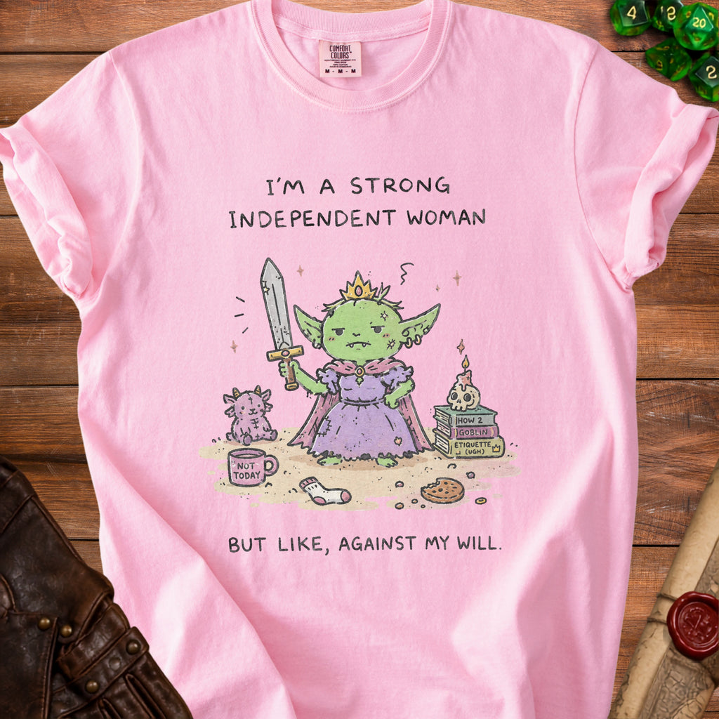 Pink t-shirt with graphic of a crowned goblin holding a sword and text "I'm a strong independent woman but like, against my will."