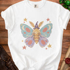 White t-shirt featuring a whimsical moth wearing a witch hat and surrounded by stars.