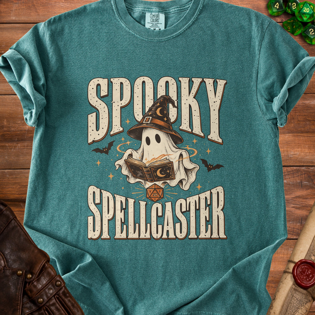 Teal t-shirt with "Spooky Spellcaster" text and a ghost wearing a witch hat reading a book.