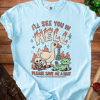 Light blue t-shirt with "I'LL SEE YOU IN HELL" and a duck, skeleton, and cat.