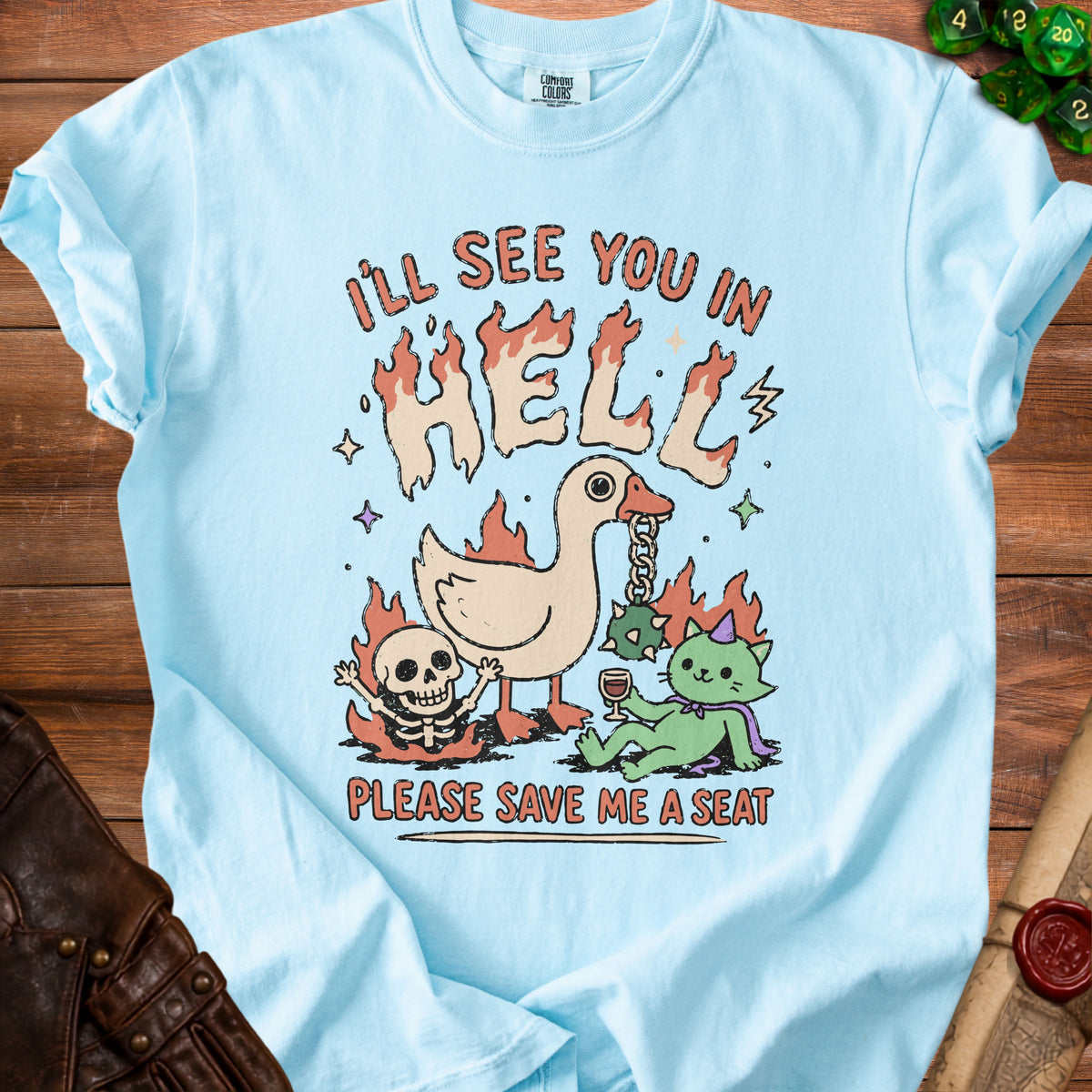 Light blue t-shirt with "I'LL SEE YOU IN HELL" and a duck, skeleton, and cat.