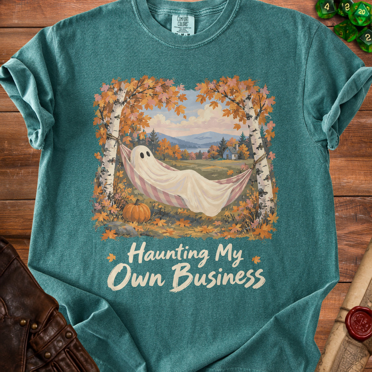 Ghost in hammock with "Haunting My Own Business" text and autumn scene.