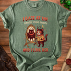 Green t-shirt with moth-cat and mirror graphic and text "I gaze at the monster I have become and I love her".