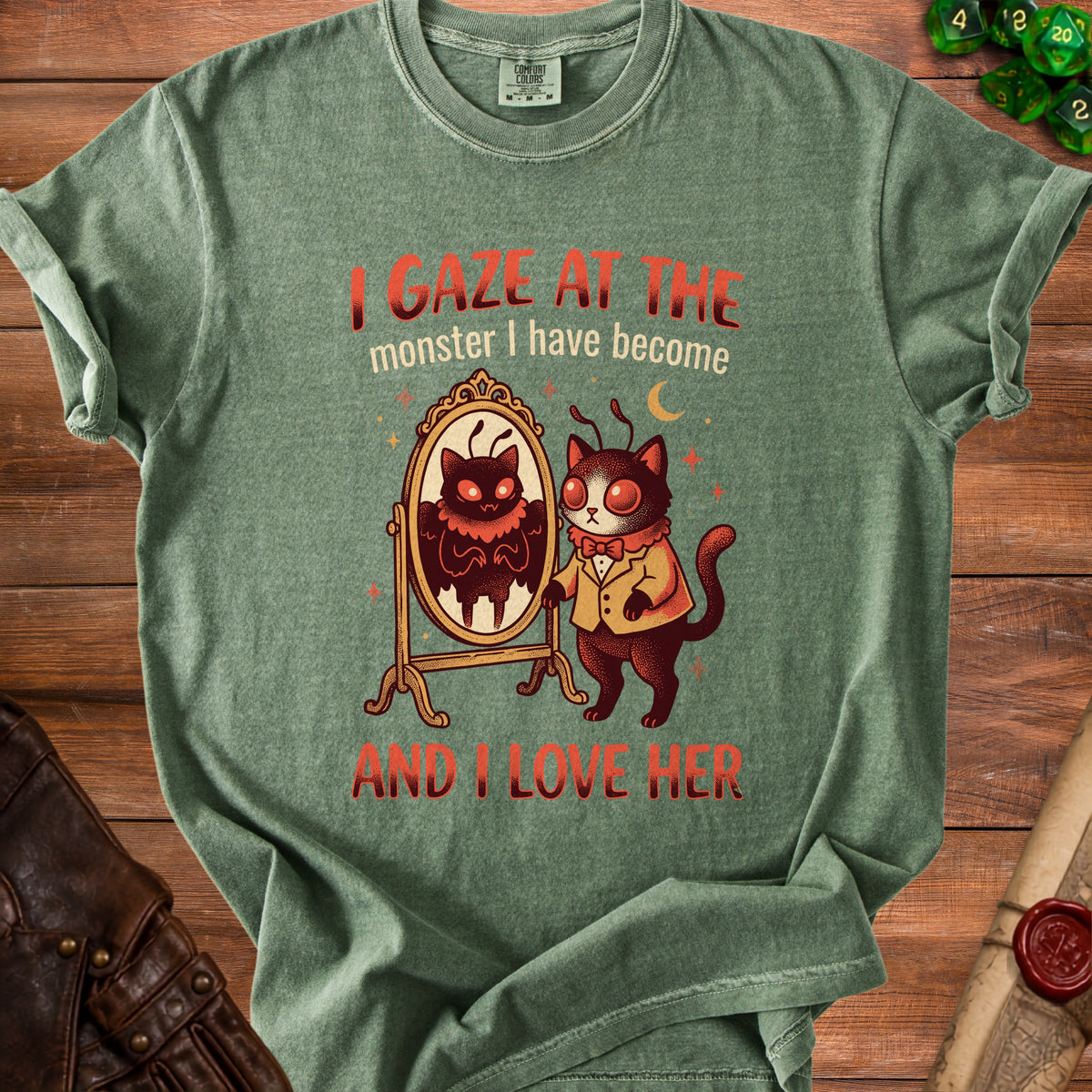Green t-shirt with moth-cat and mirror graphic and text "I gaze at the monster I have become and I love her".