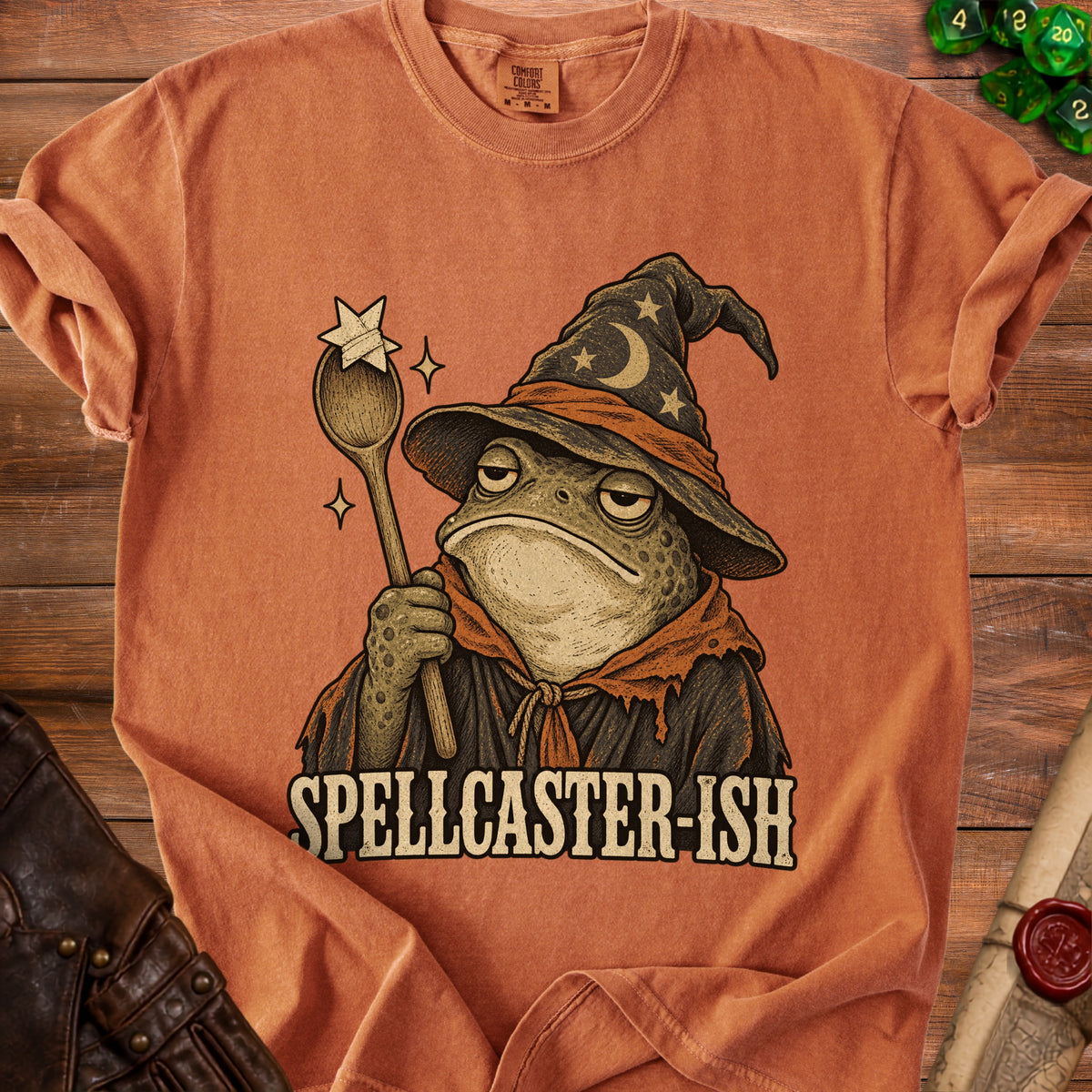 Orange t-shirt with a cartoon toad wizard holding a wand and text "SPELLCASTER-ISH".