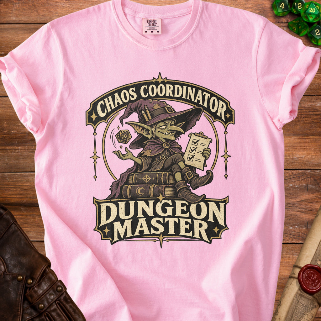Light pink t-shirt featuring a goblin graphic, dice, and the text Chaos Coordinator Dungeon Master.