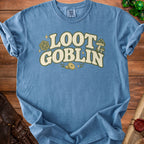 Blue t-shirt with "Loot Goblin" text and D20 dice graphic.