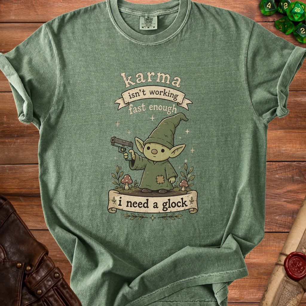 Green t-shirt graphic of a gnome holding a gun, with text "karma isn't working fast enough i need a glock".