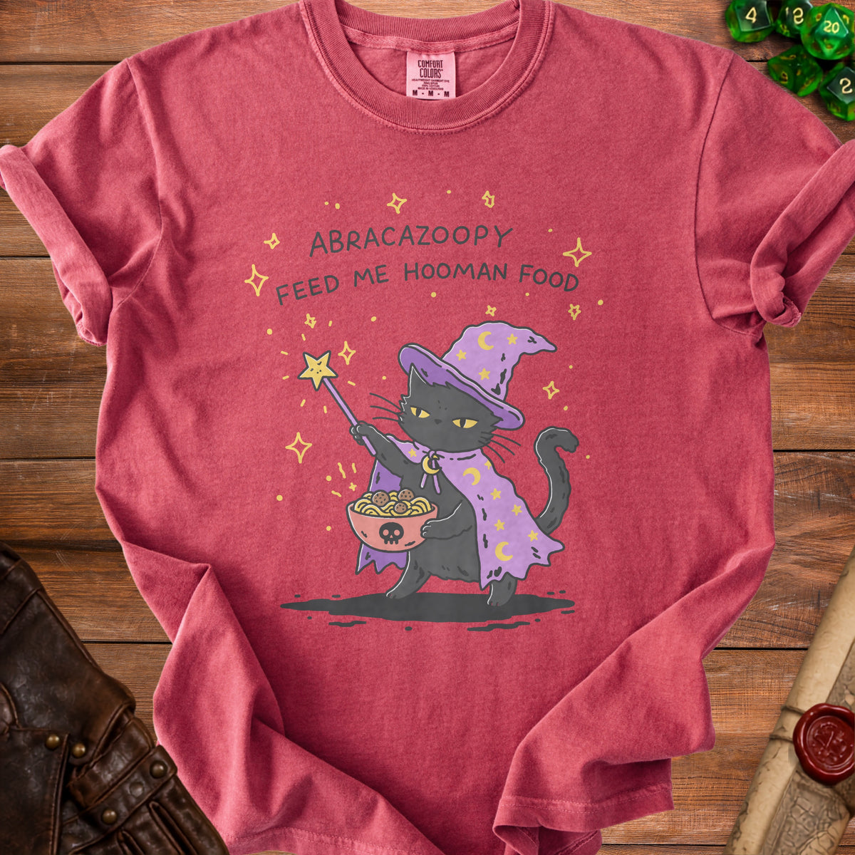 T-shirt with a black cat wearing a wizard hat, holding spaghetti and meatballs.