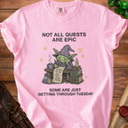 Pink t-shirt with a tired goblin wizard and text "Not All Quests Are Epic".