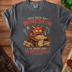 T-shirt graphic of a red monster writing "I'm adding doom to my scrolls".