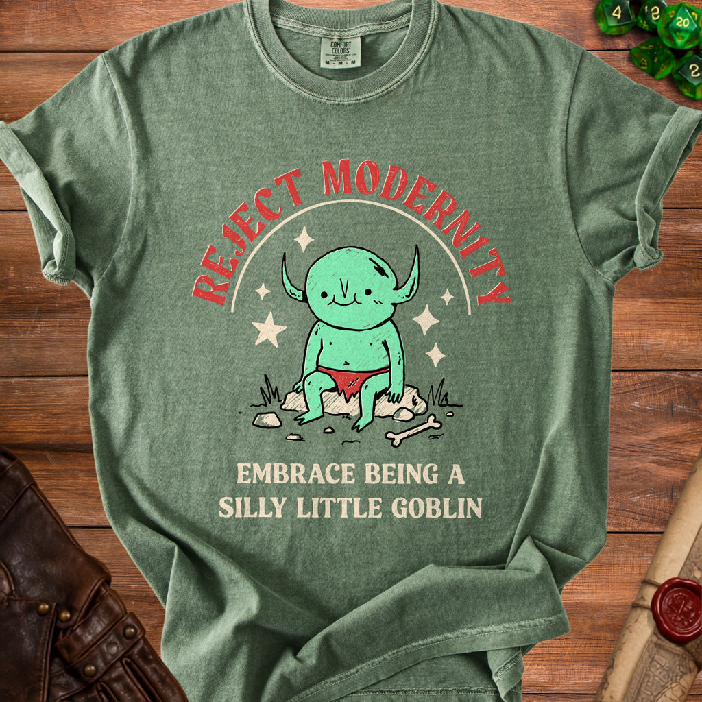 Green t-shirt with a drawing of a goblin and text "Reject Modernity Embrace Being A Silly Little Goblin".