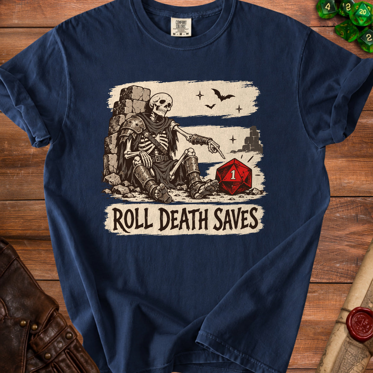 Skeleton pointing at a die with text "Roll Death Saves" on a navy shirt.