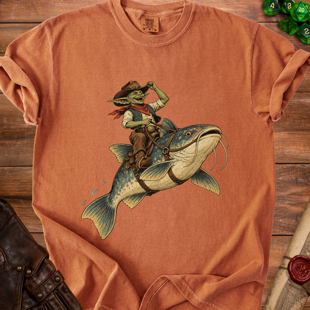 Goblin cowboy riding a catfish on a vintage-style t-shirt design.