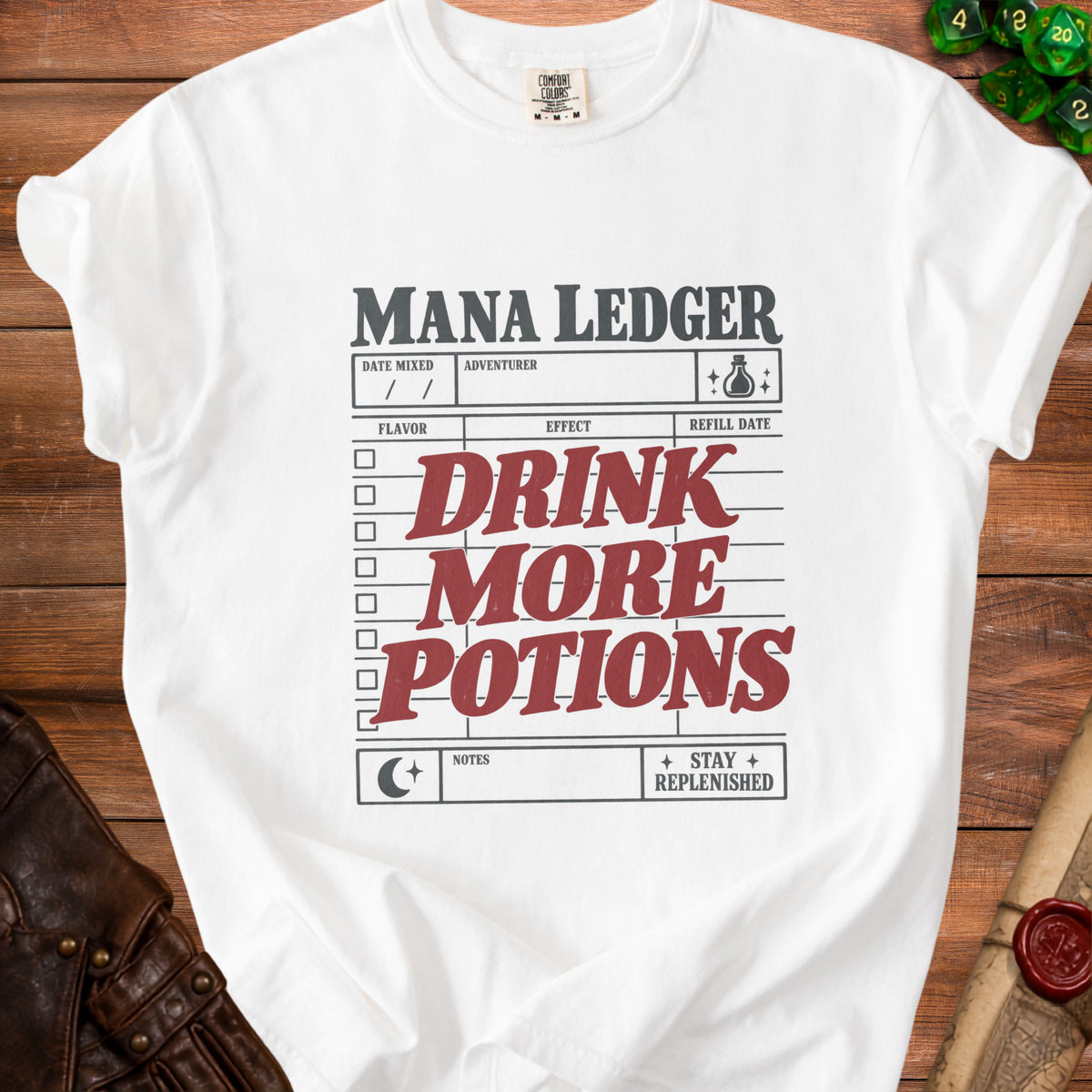 White t-shirt with "MANA LEDGER DRINK MORE POTIONS" text and potion graphics.