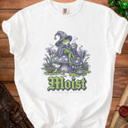 White t-shirt with a wizard frog sitting on a mushroom, holding a mug and reading "Moist".