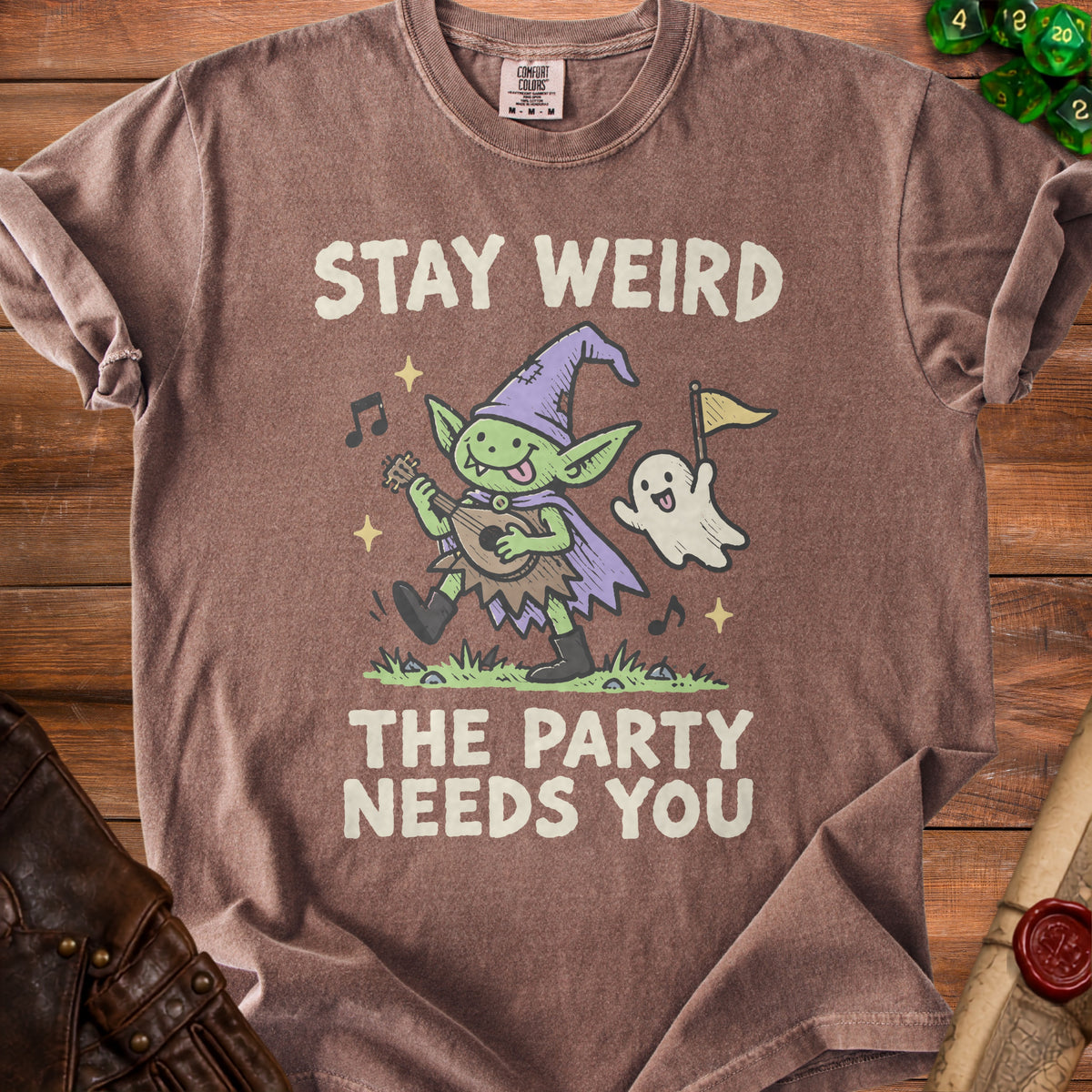 Brown t-shirt with "Stay Weird The Party Needs You" text and goblin and ghost illustration.