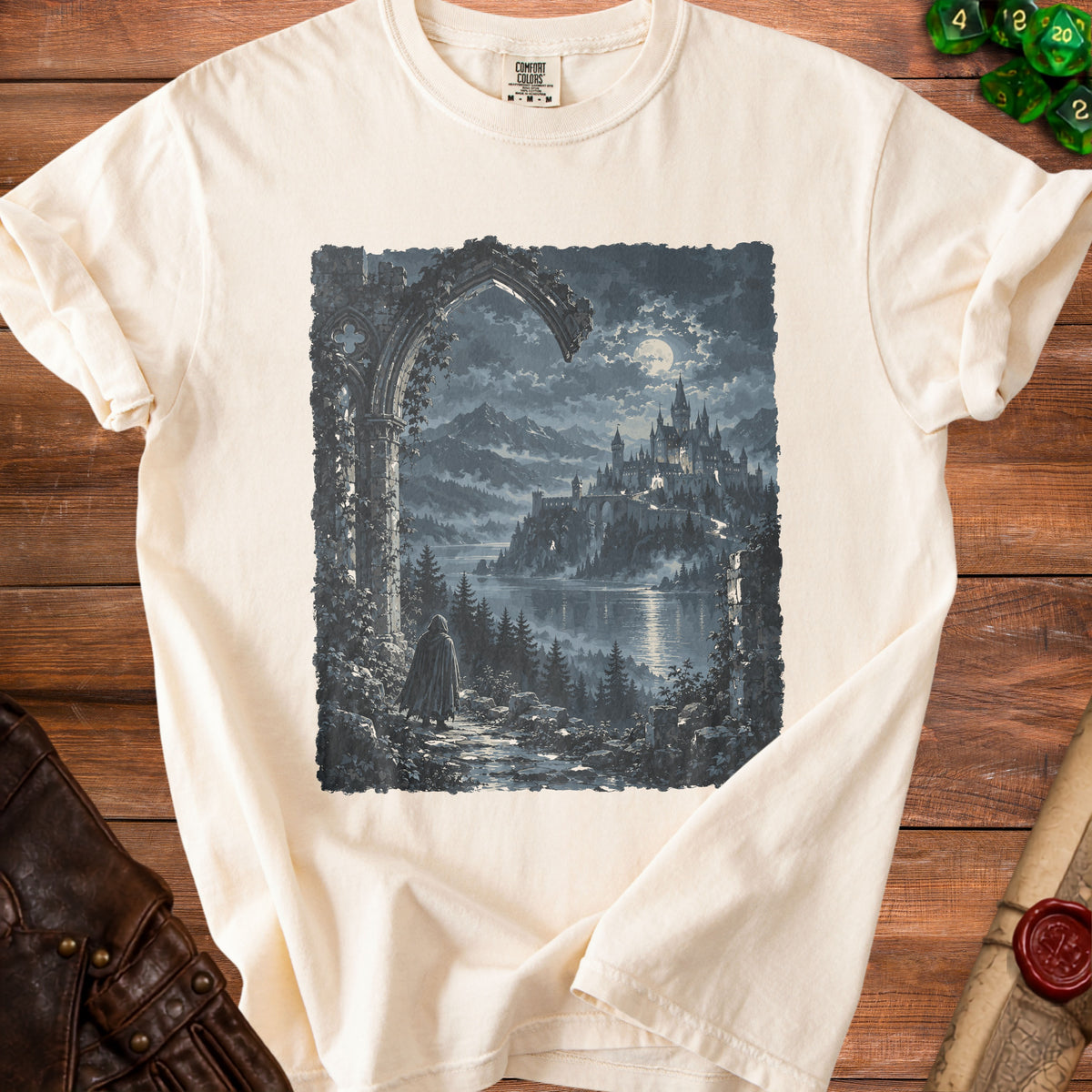 Cream t-shirt with a dark, moonlit castle and cloaked figure design.