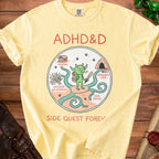 Yellow t-shirt with ADHD&D cartoon, tavern, dragon's lair, and side paths.