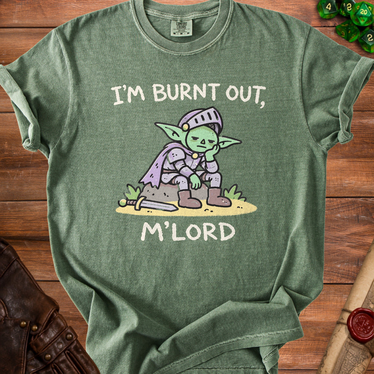 Green t-shirt with a cartoon goblin knight saying "I'M BURNT OUT, M'LORD".