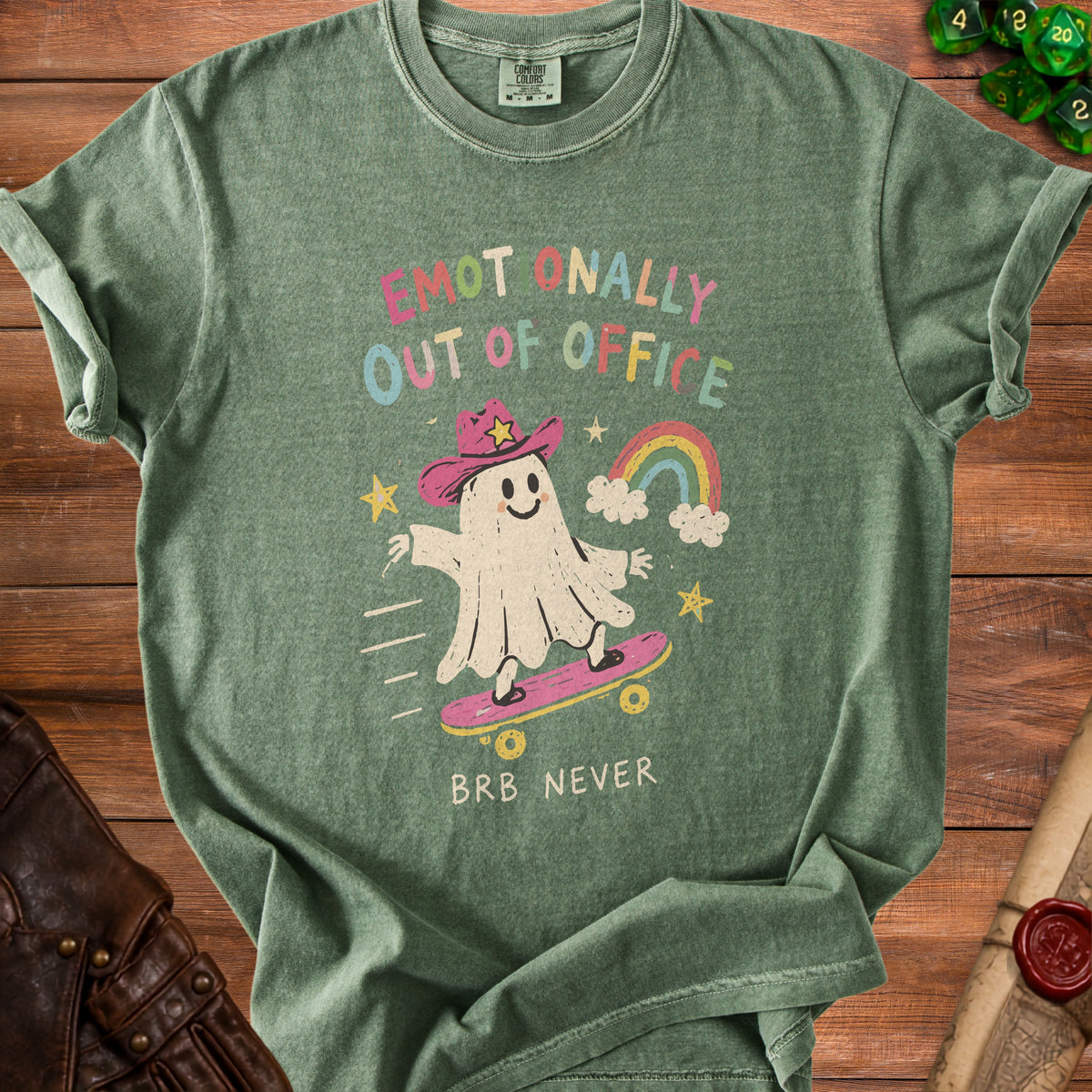 Green t-shirt with ghost skateboarding and text "Emotionally Out of Office BRB Never".