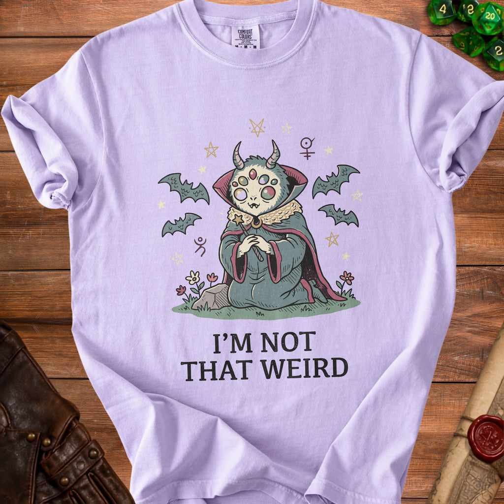 Lavender t-shirt with a creature, bats, stars, and the text "I'M NOT THAT WEIRD".