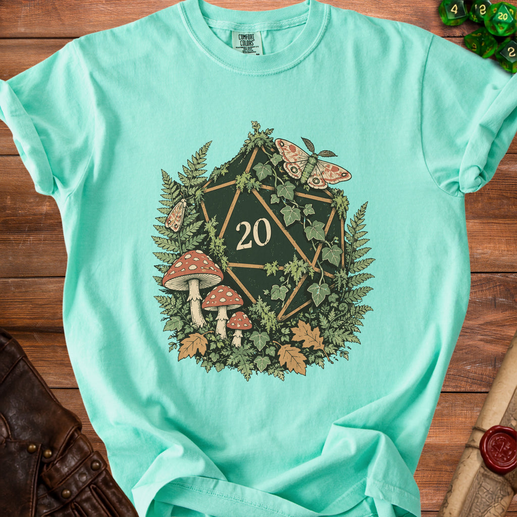 Teal t-shirt with a dark green twenty-sided die surrounded by ferns, mushrooms, and moths.