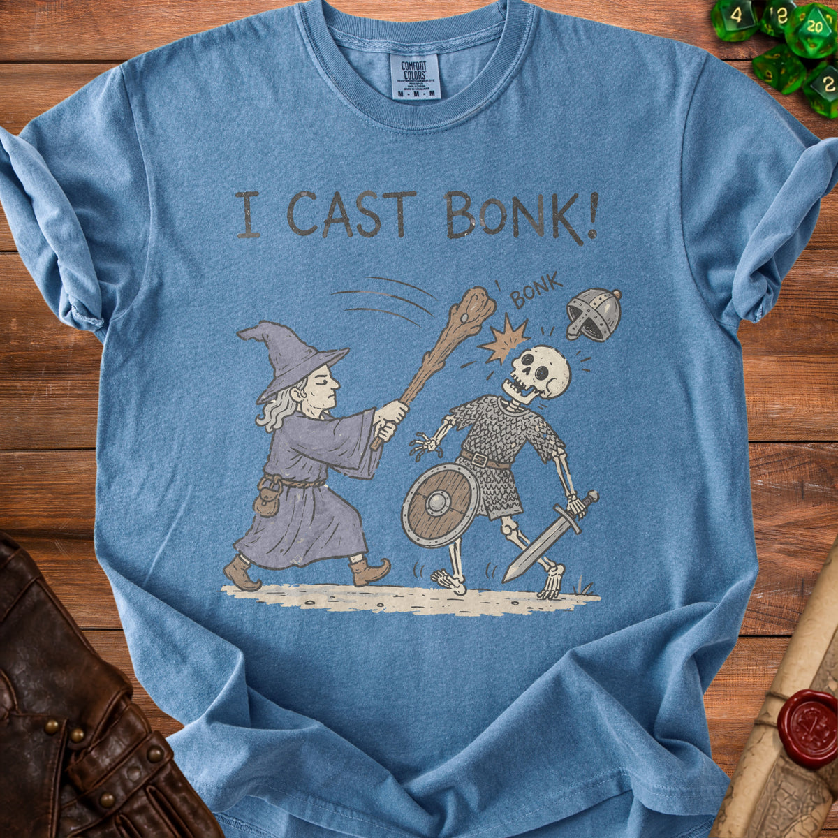 Blue t-shirt with wizard hitting skeleton with club, reads "I CAST BONK!".