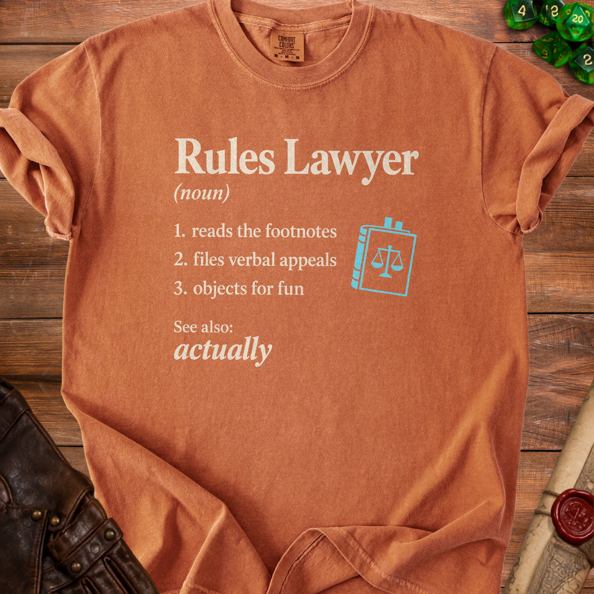 Orange t-shirt with "Rules Lawyer" definition and a book with scales icon.