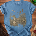 Blue t-shirt with a vintage illustration of a dragon, dragonfly, and d20 dice.