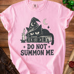Pink t-shirt with black cat in witch hat on books, text "DO NOT SUMMON ME".