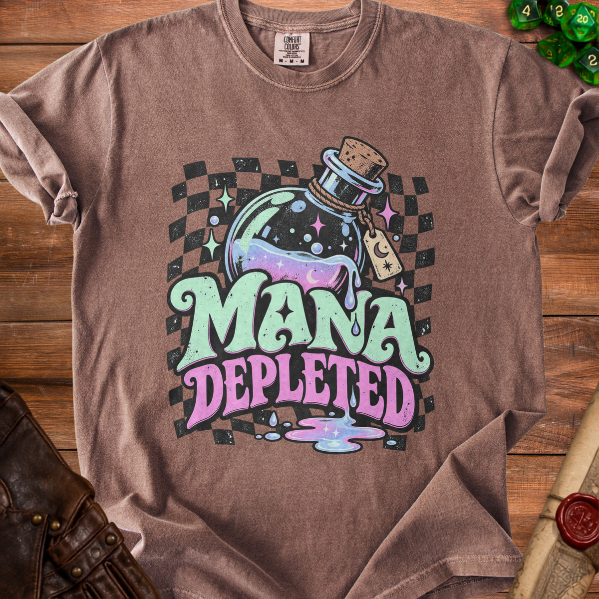 Brown t-shirt with "MANA DEPLETED" text, potion bottle, and checkered background.