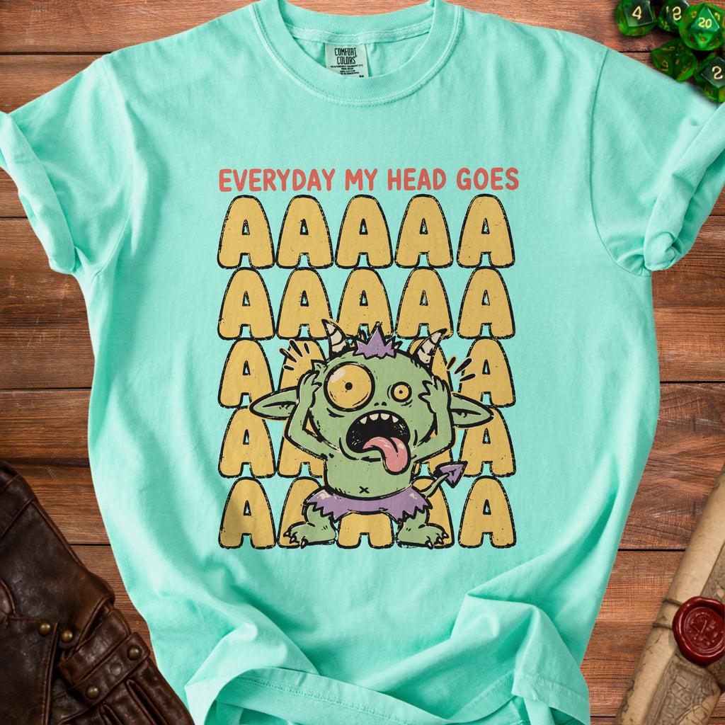 Mint green t-shirt with a distressed graphic of a screaming monster and "EVERYDAY MY HEAD GOES AAAAA" text.