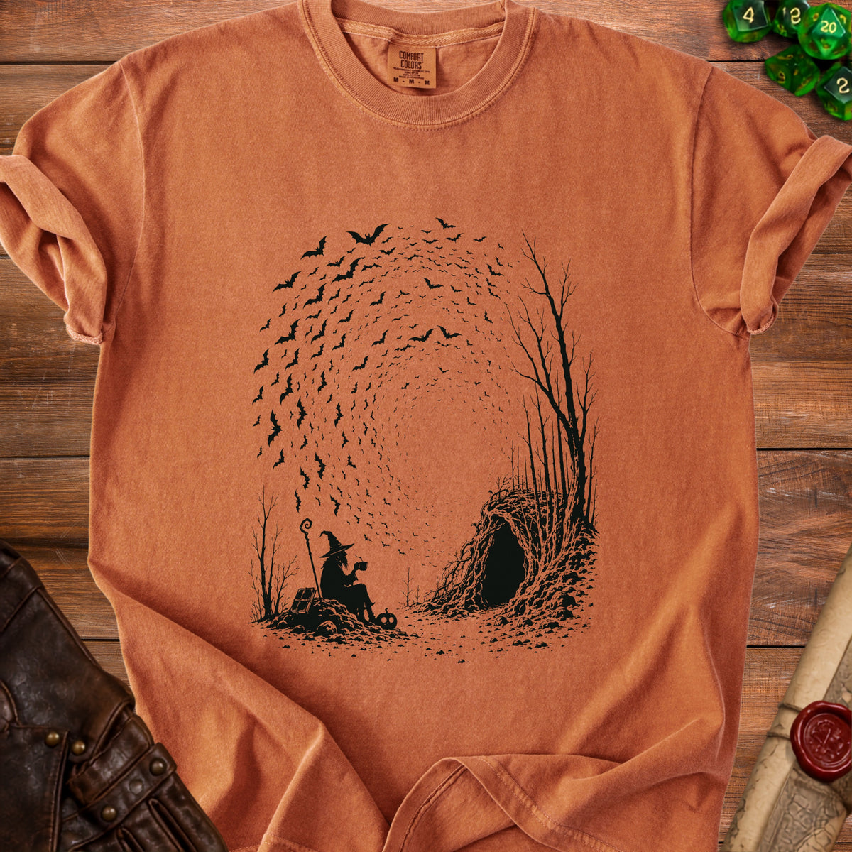 Silhouette of witch with staff drinking tea by a cave entrance with swirling bats.