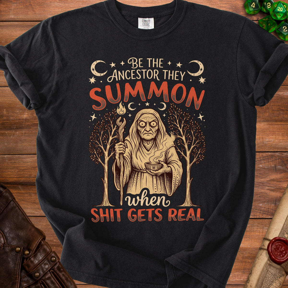 Black t-shirt with graphic: "Be the ancestor they summon when shit gets real"