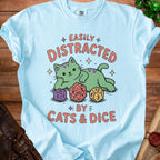 Light blue t-shirt with green cat, dice, and "Easily Distracted by Cats & Dice" text.