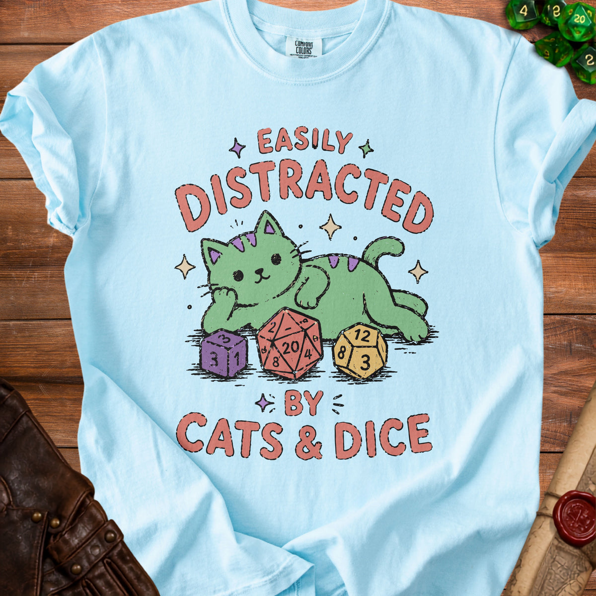 Light blue t-shirt with green cat, dice, and "Easily Distracted by Cats & Dice" text.
