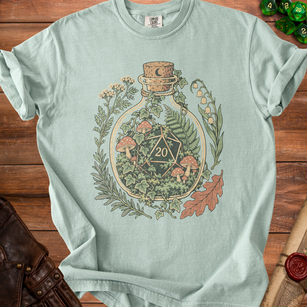 Light blue t-shirt with graphic of d20 dice inside a bottle with mushrooms and plants.