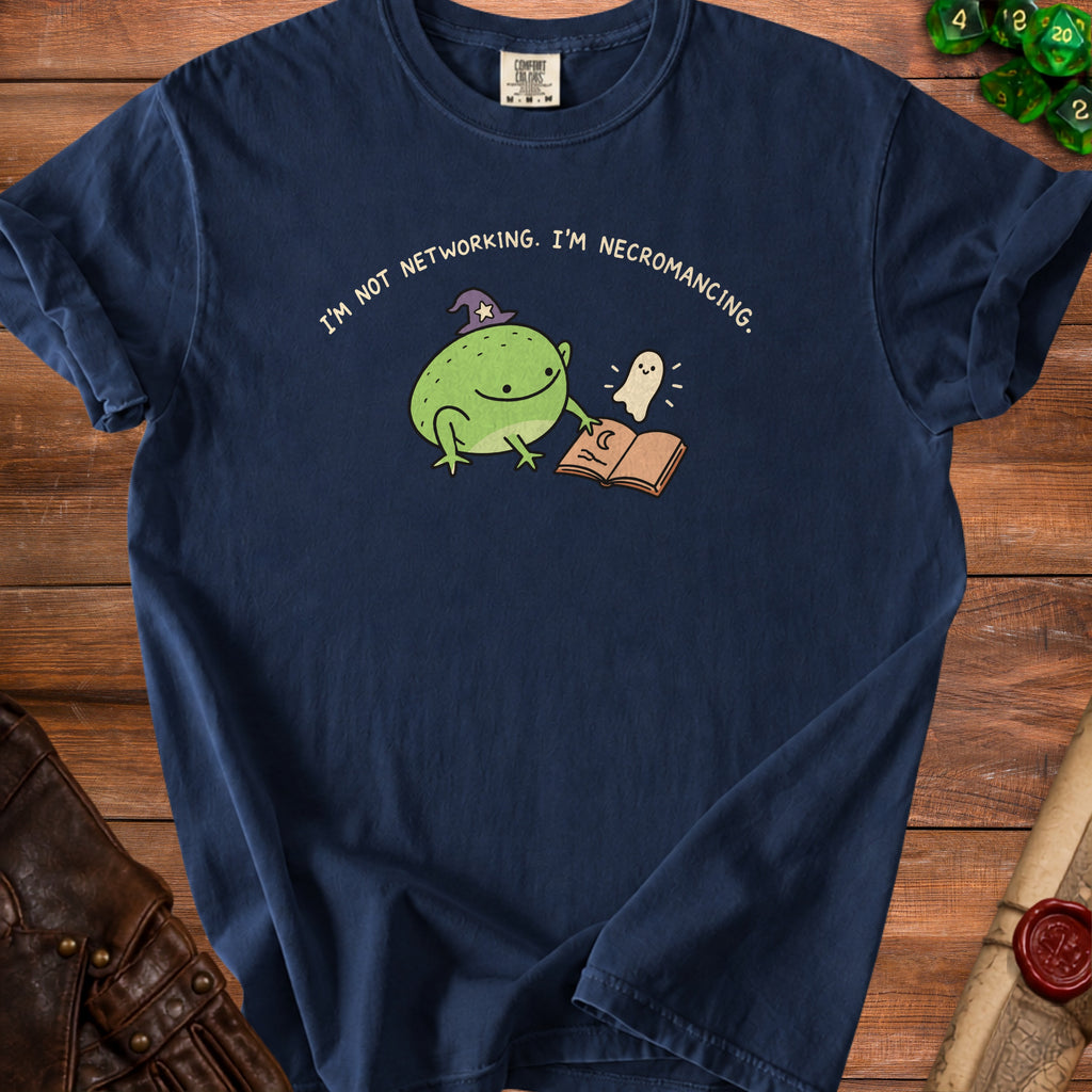 Navy t-shirt with a graphic of a frog in a wizard hat and a ghost reading a book.