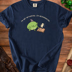 Navy t-shirt with a graphic of a frog in a wizard hat and a ghost reading a book.