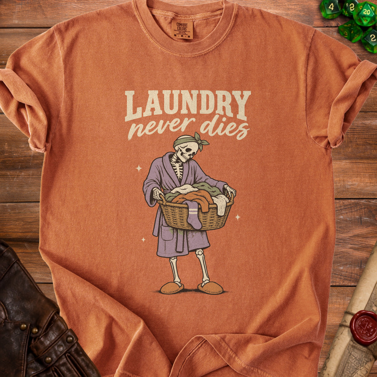 Skeleton wearing bathrobe and holding laundry basket with text "LAUNDRY never dies".