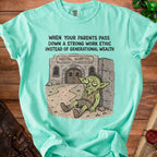 Mint green t-shirt with cartoon of tired goblin outside "Mental Hospital" and text "When your parents pass down a strong work ethic instead of generational wealth."