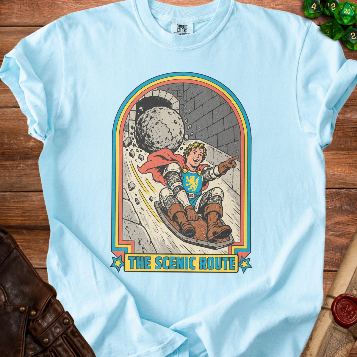 Knight sledding downhill from a castle arch, text reads "The Scenic Route."