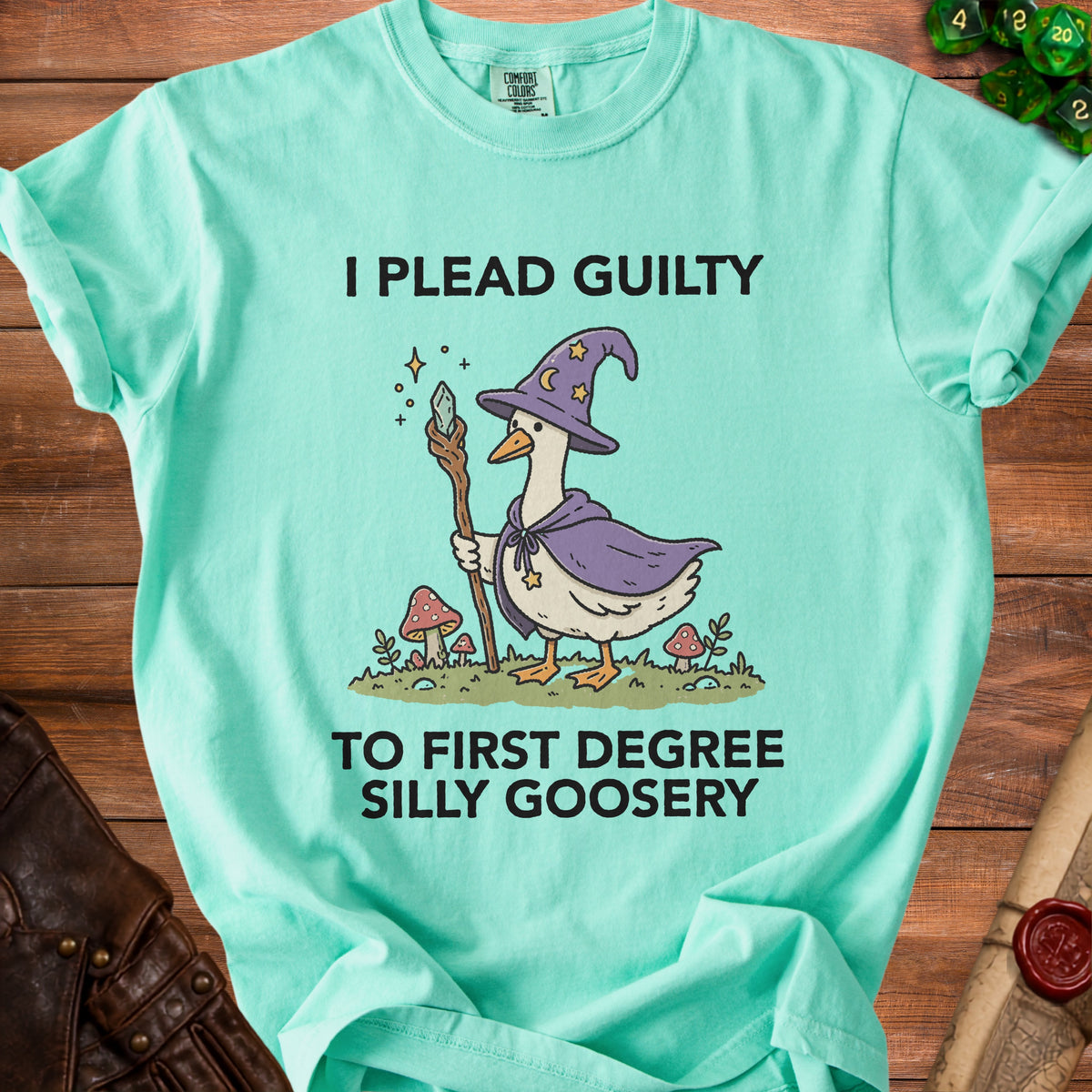 Light teal t-shirt with illustration of a goose in a wizard hat and cape.