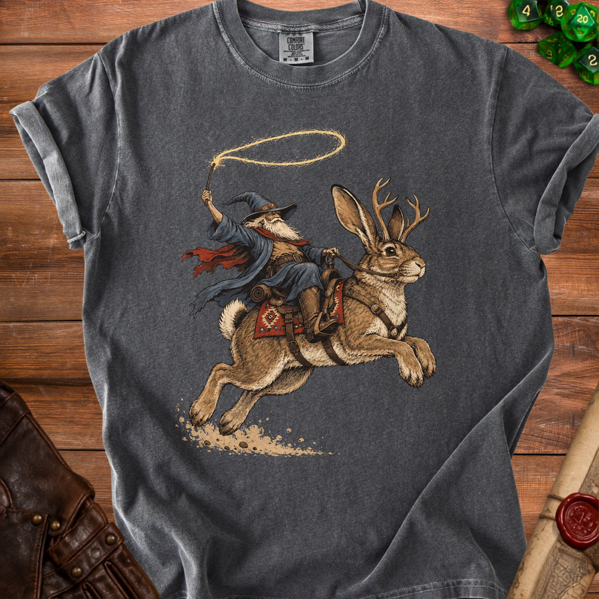 Wizard riding a jackalope with antlers and a lasso, on a dark gray t-shirt.