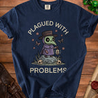 Dark blue t-shirt with plague doctor graphic and text "PLAGUED WITH PROBLEMS."