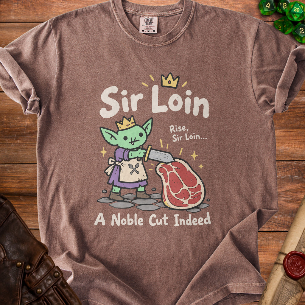 Brown t-shirt with a cartoon goblin and steak design, reading "Sir Loin" and "A Noble Cut Indeed".