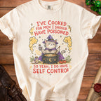 Cream t-shirt with a witch cat stirring a cauldron and text "I've cooked for men I should have poisoned, so yeah I do have self control."