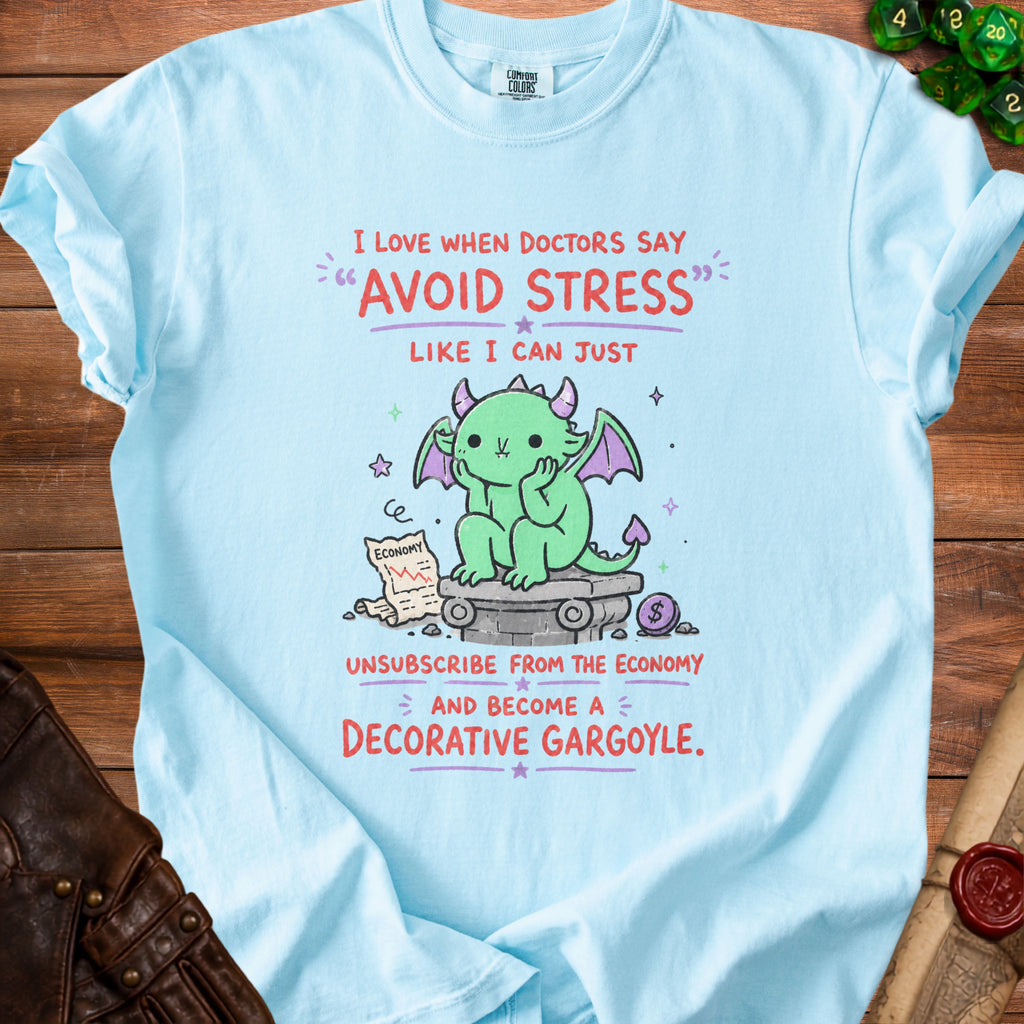 Light blue t-shirt with a cartoon dragon and text about avoiding stress and becoming a decorative gargoyle.
