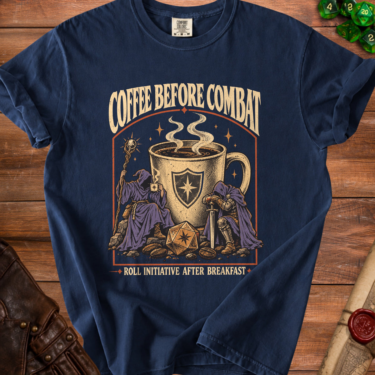 Navy t-shirt graphic with wizards, knight, coffee, dice, and text.